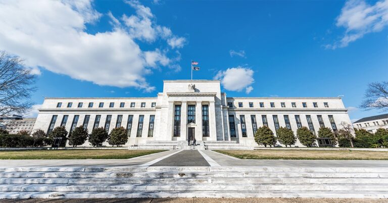 Fed pauses interest rate cuts, with future easing uncertain.