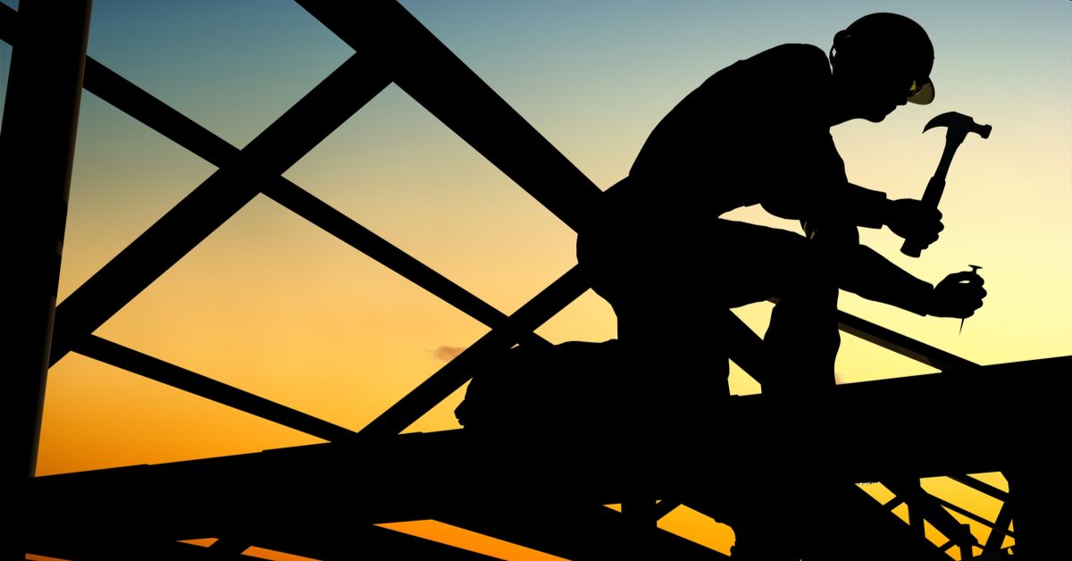 CONSTRUCTION Silhouette of man building house