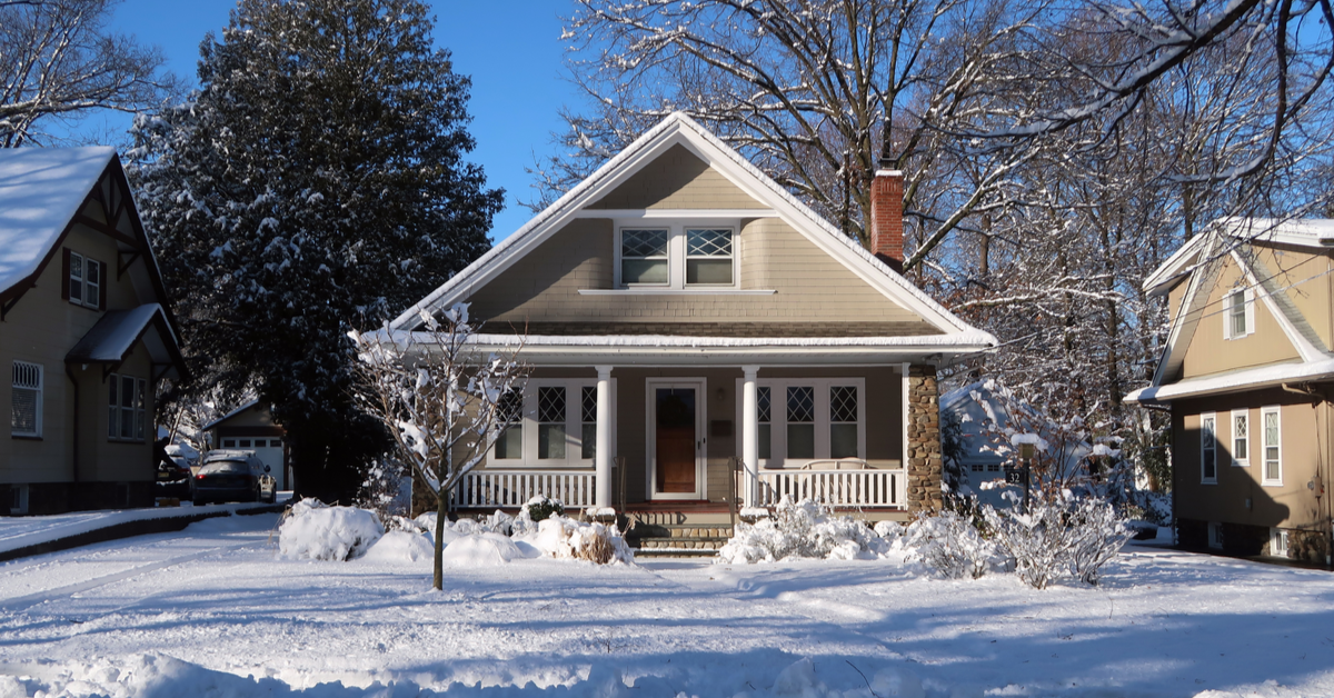 HOUSE Small winter bungalow covered in snow