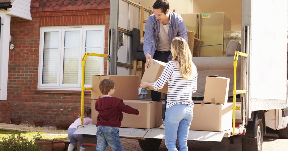 PEOPLE Family unpacking boxes from moving truck