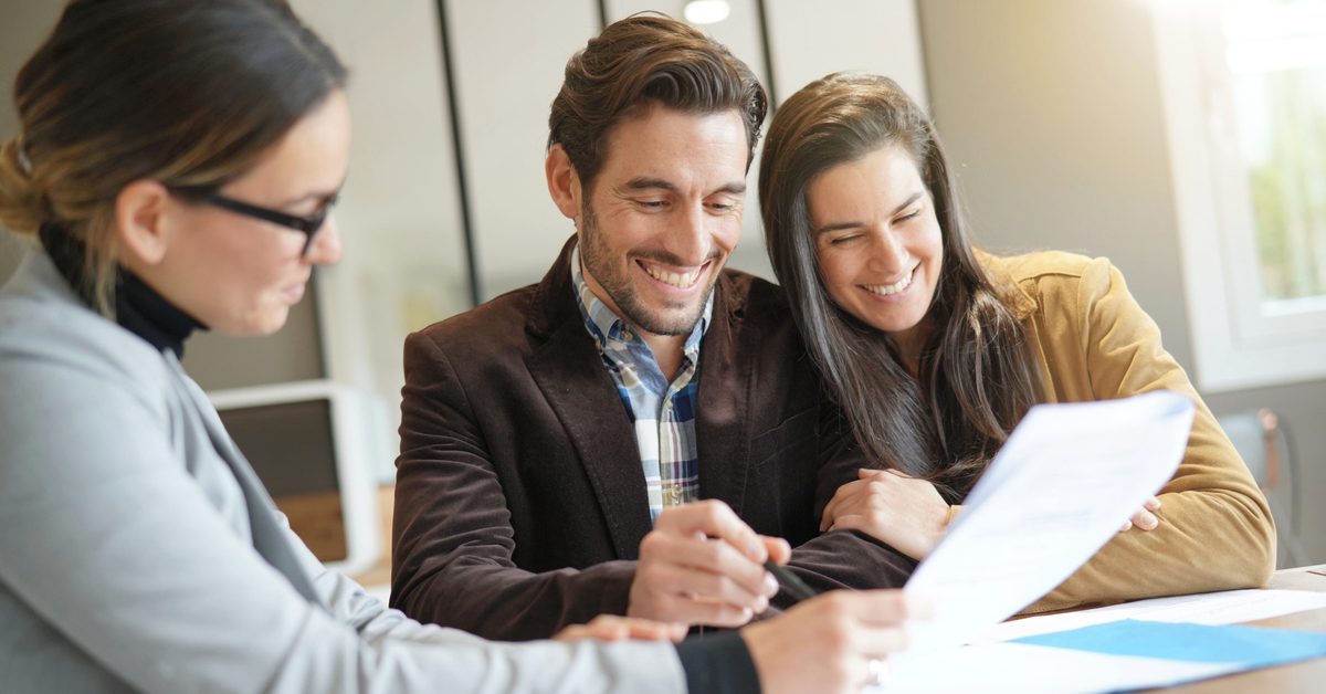 PEOPLE Millennial couple signing mortgage contract