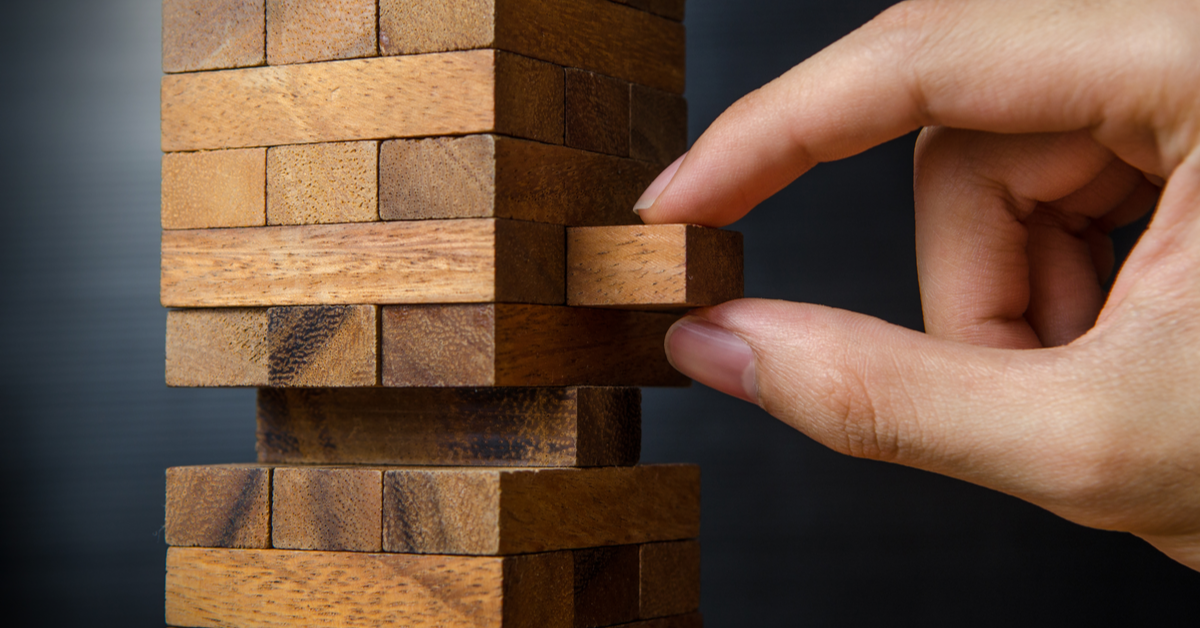 CONCEPT Risk, taking block from Jenga tower