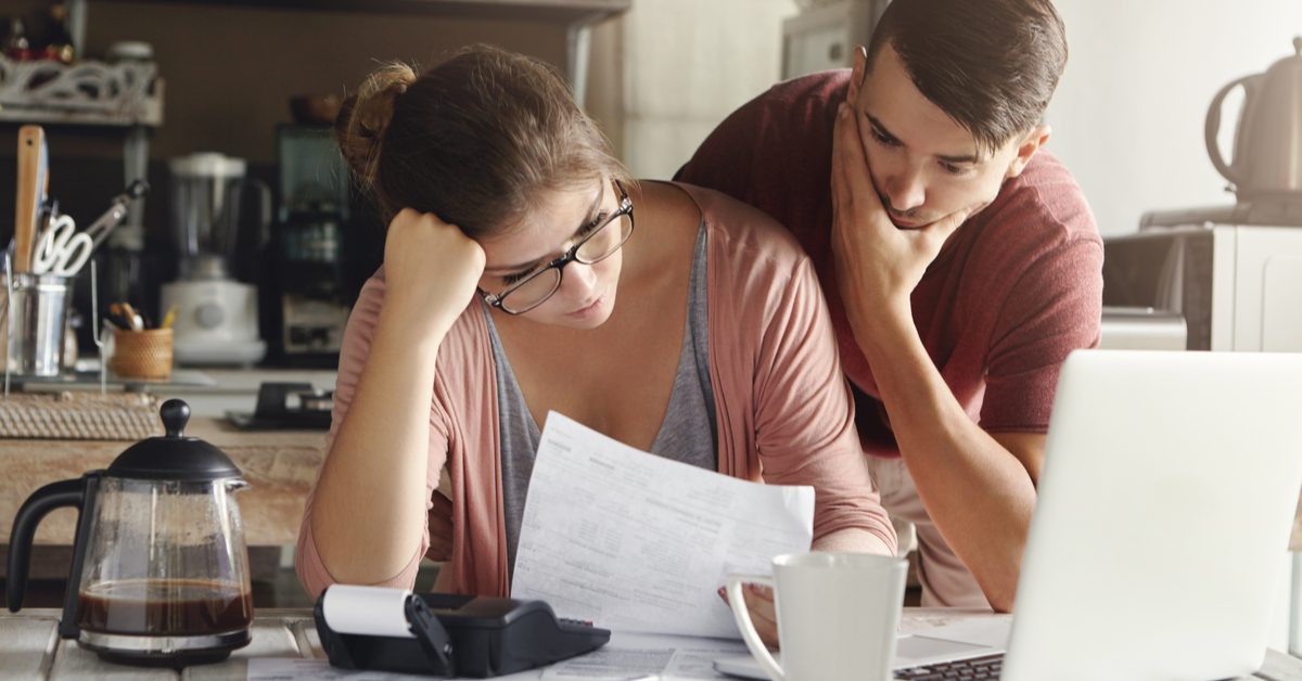 PEOPLE Frustrated borrowers looking at loan documents