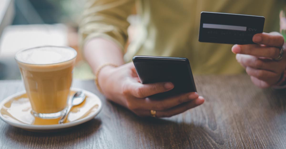 CONCEPT Banking at a coffee shop with phone