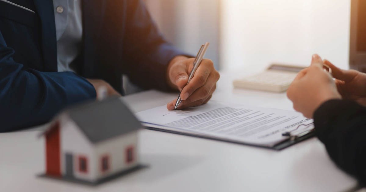CONCEPT Filling out paperwork on desk house model