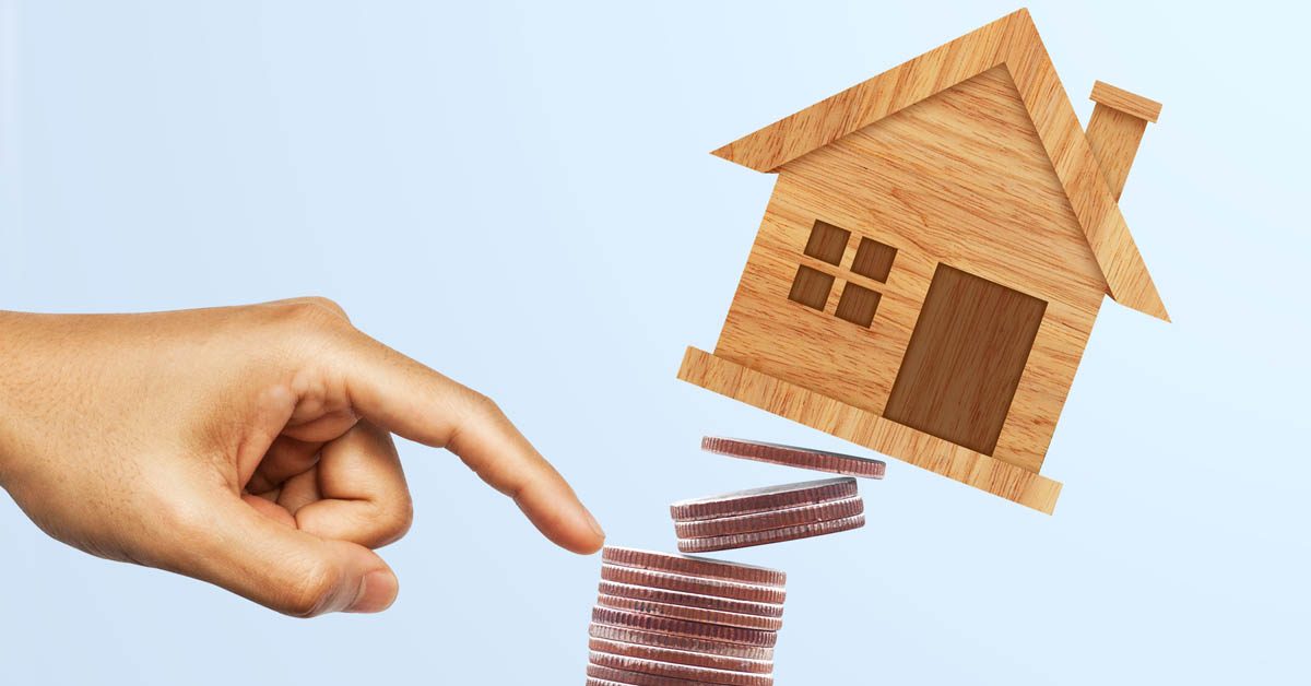 CONCEPT Finger pushing pile of coins and model house