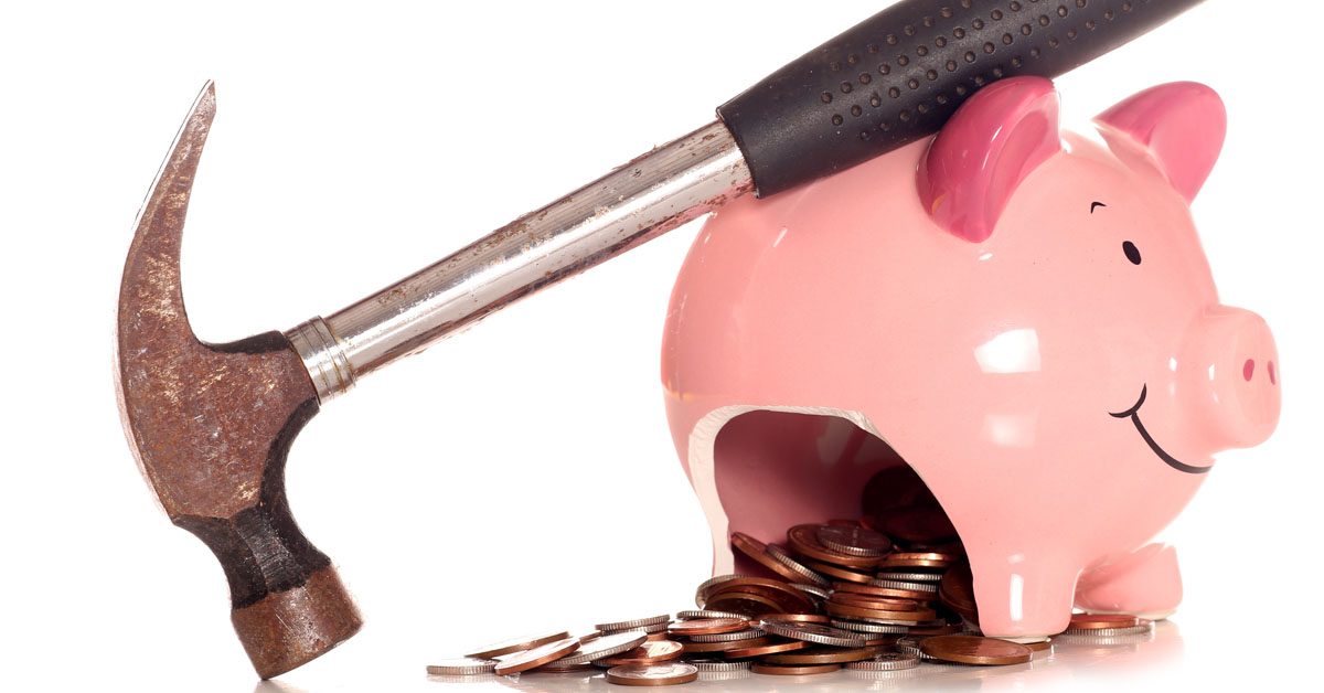CONCEPT Smashed piggy bank with overflowing coins