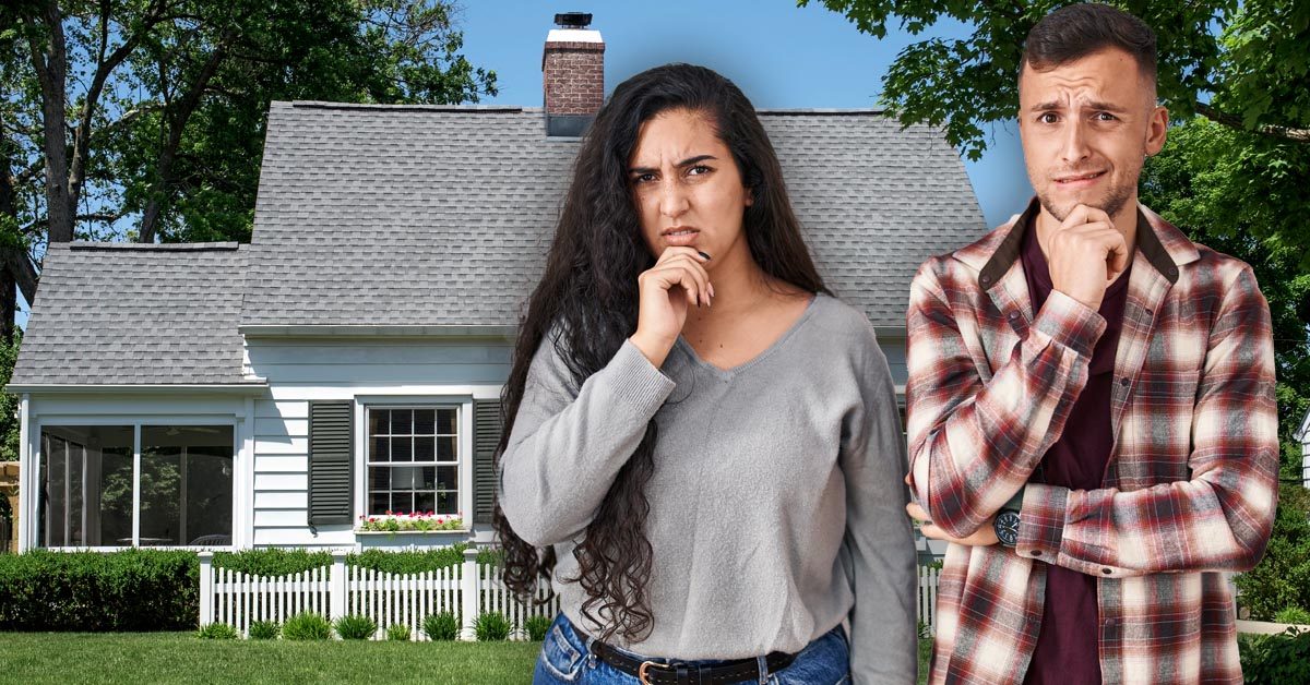 HOUSE PEOPLE Worried young couple outside starter home
