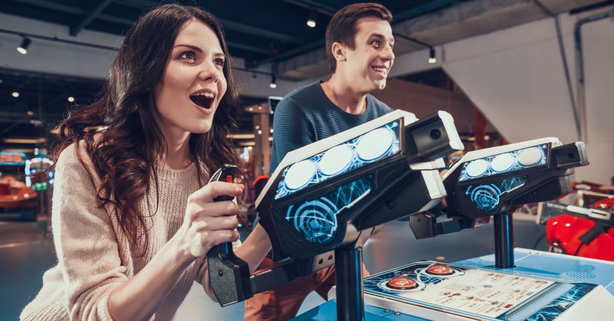 PEOPLE Young couple having fun at barcade