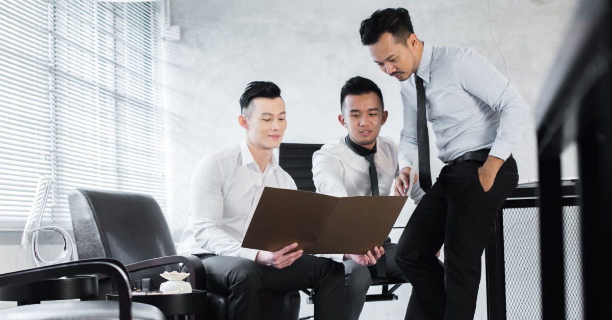 PEOPLE Business team of young male professionals in office