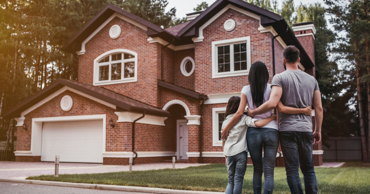 HOUSE PEOPLE Happy family standing near modern new house