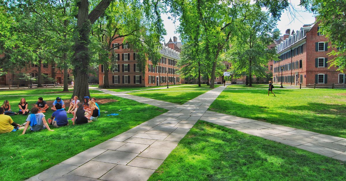 Students on quad with dorms in background