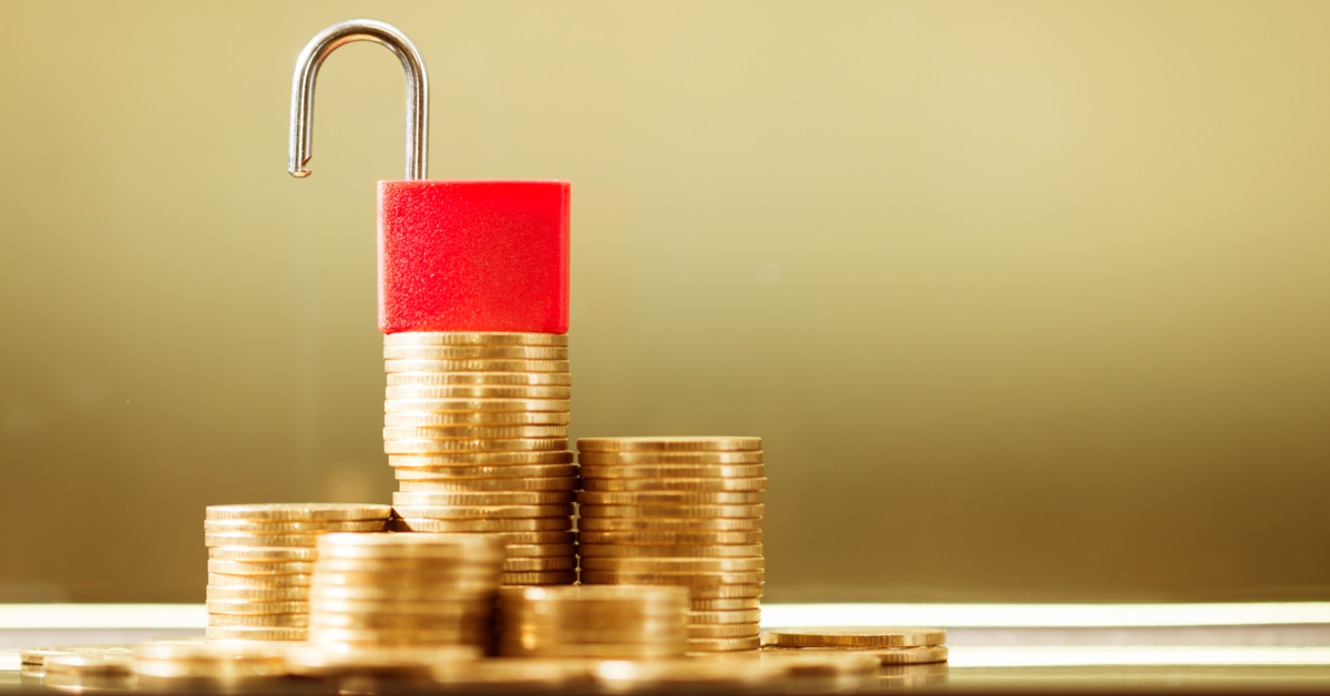 CONCEPT Stack of coins with unlocked lock