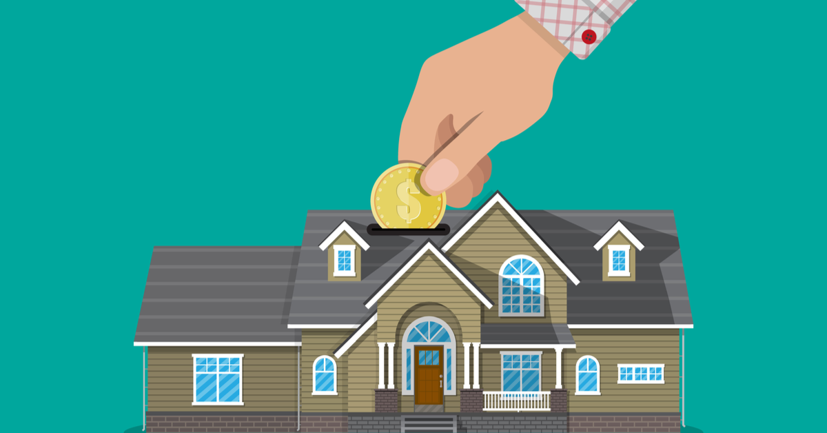 CONCEPT Hand putting coin in piggy bank house