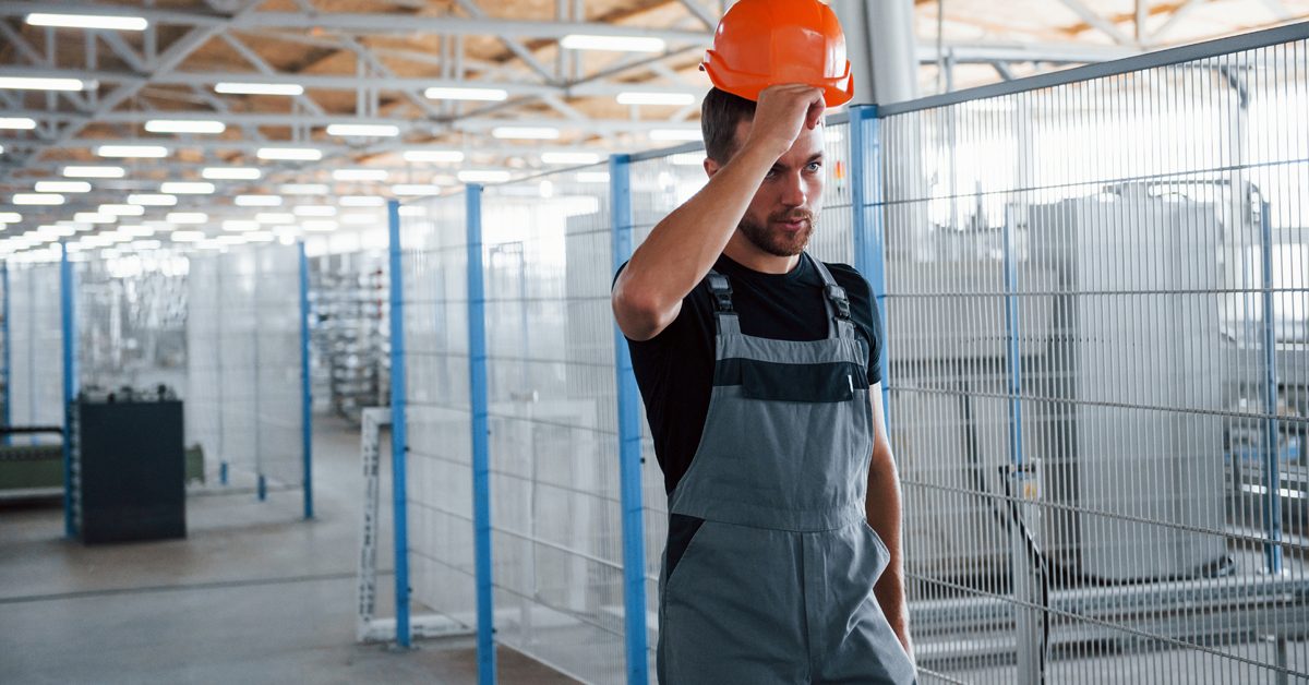 d06a6d8b_Industrial-Worker-Taking-Off-Hard-Hat