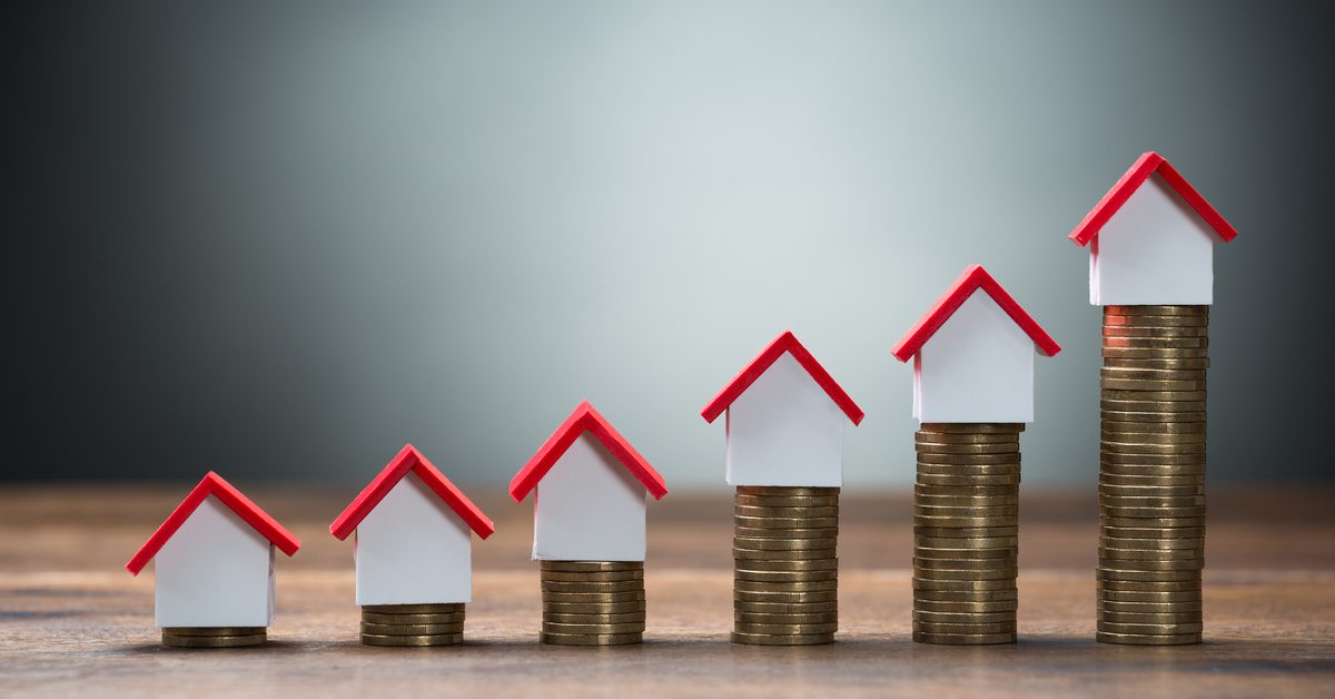 CONCEPT Rising house prices on coin stacks