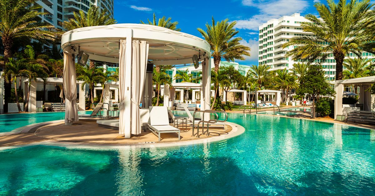 Hotel pool area with palm trees