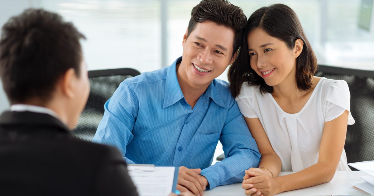 PEOPLE Happy couple consulting real estate agent