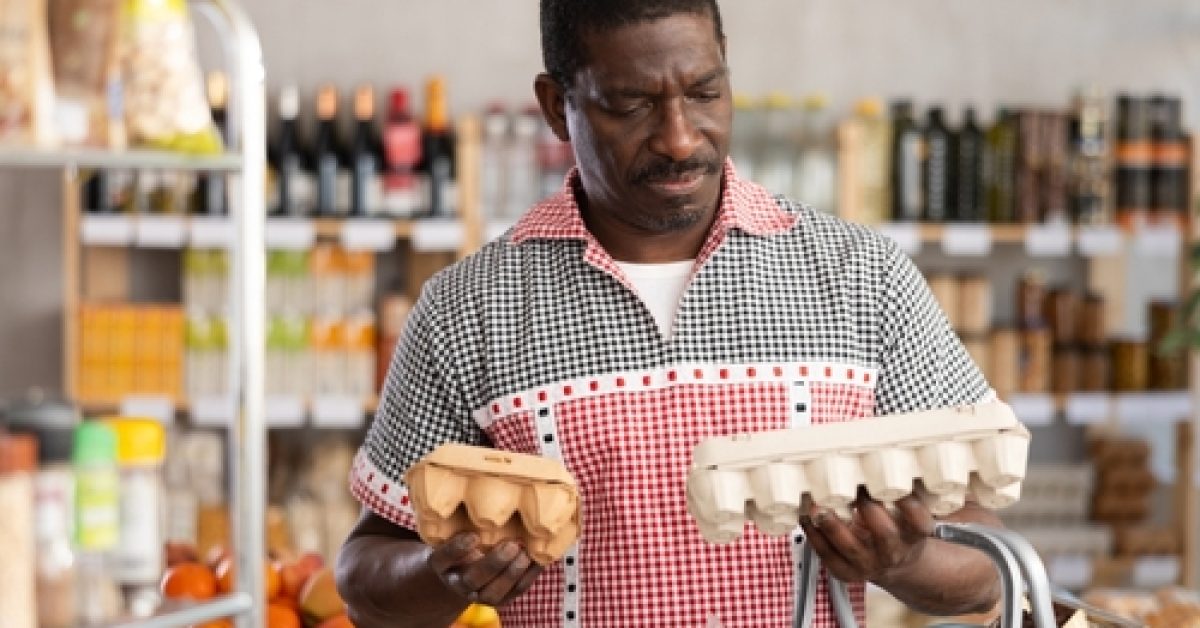African,Man,Is,Holding,Eggs,Container,Packages,In,Hands,,Choosing